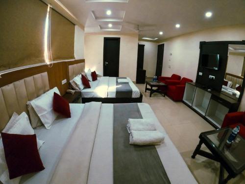 a large room with two beds and a living room at Hotel AG Royal Affordable Blissful Stay in Haridwār
