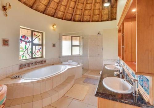 a bathroom with two sinks and a large tub at 205 Zebula, 4 bedroom house in Warmbaths