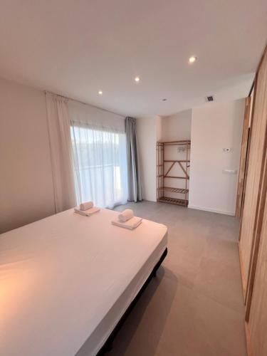 a bedroom with a large bed with two towels on it at Camping Joncar Mar in Roses