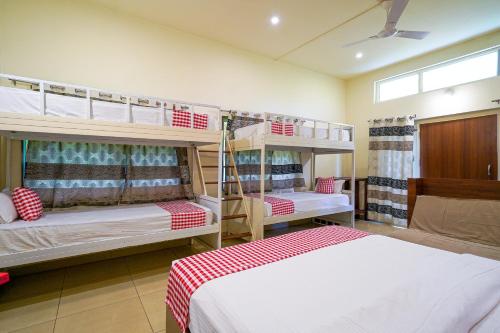 a room with two bunk beds in a room at Open Hotel by Olive - Biranji Aqua Reatreat in Chikmagalūr