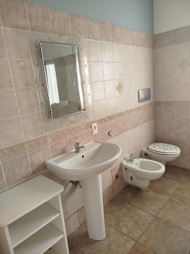 a bathroom with a sink and a toilet at La Casa di Elisa Affittacamere in Gravellona Toce