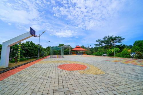 a basketball court with a basketball hoop in a park at Open Hotel by Olive - Biranji Aqua Reatreat in Chikmagalūr