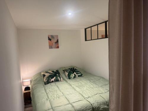 a small bedroom with a bed in the corner at Appartement atypique chaleureux in Rosières-devant-Bar