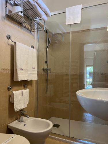 a bathroom with a shower and a sink and a toilet at Masseria Casina Montana in Corigliano dʼOtranto