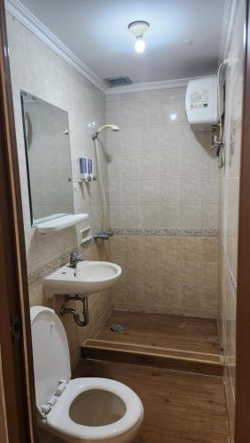 a bathroom with a toilet and a sink at Majesty Apartemen Strategis Dekat Mall Toll Dan segalanya in Bandung