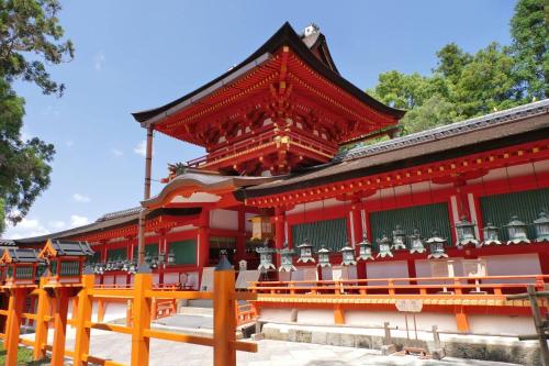 a red building with chairs in front of it at 大和の宿 Kitabukuro201 in Nara