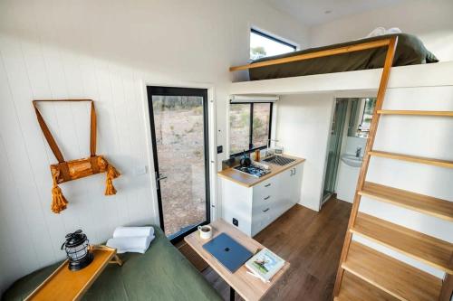 a tiny house with a staircase and a sink at Lovely Tiny House with Barbecue in Maiden Gully, Victoria in Woodvale