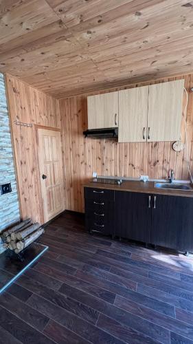 a kitchen with wooden walls and a counter top at House on Fontan in Odesa