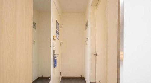 a hallway with white walls and doors in a building at 7 Days Inn Suzhou Mudu Ancient Town Kaima Auto Market in Suzhou