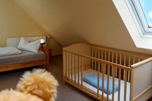 a baby room with a crib and a stuffed animal at Ferienzentrum Yachthafen Rechlin in Rechlin