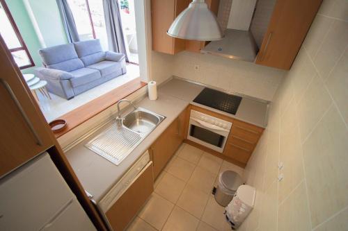 an overhead view of a small kitchen with a couch at Burriana Beach Apartment in Nerja