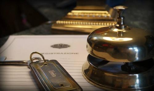 a small metal object sitting on top of a notebook at Hotel Livio in Brescia