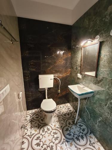 a bathroom with a toilet and a sink at AH South premium 6BHK w Private Pool in Jaipur