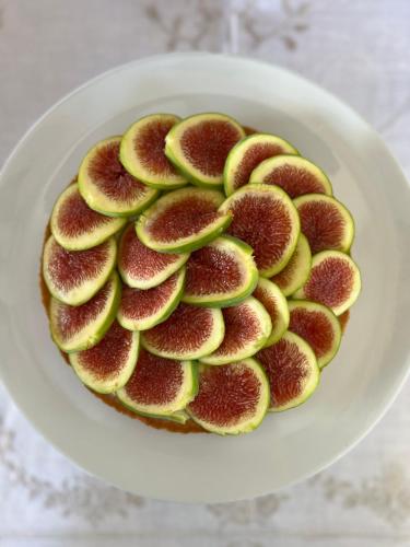 a white plate with a fig cake on a table at Masseria Casina Montana in Corigliano dʼOtranto