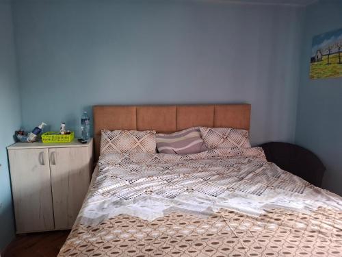 a bedroom with a large bed with a wooden headboard at Radovići,Luštice in Radovići