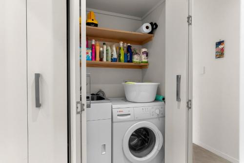 a laundry room with a washer and dryer at Seaview - Mangawhai Heads Holiday Home in Mangawhai