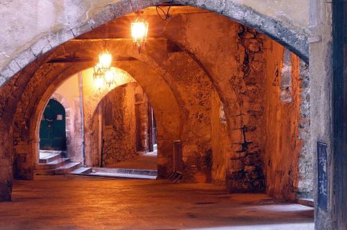 an empty hallway with an archway in a building at Welcome Hotel in Villefranche-sur-Mer