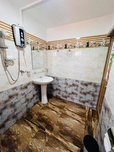 a bathroom with a white sink and a shower at Wow Field Homestay in Ella