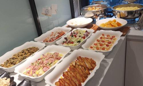 a buffet with many trays of different types of food at Daegu Dongseongro Hotel Labella in Daegu