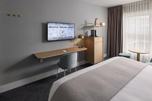 a hotel room with a bed and a desk at Van der Valk Hotel Paris CDG Airport in Roissy-en-France