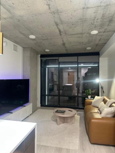 a living room with a couch and a coffee table at Modern Downtown Apartment in Salt Lake City