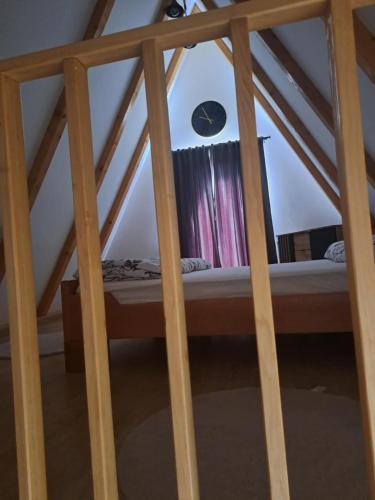 a bed in the attic of a room at Vikendica Una-Bakšaiš in Bihać