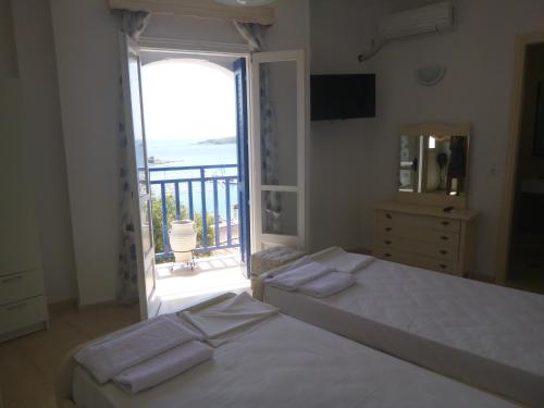 a bedroom with a bed with a view of the ocean at Paradisos House in Skiathos