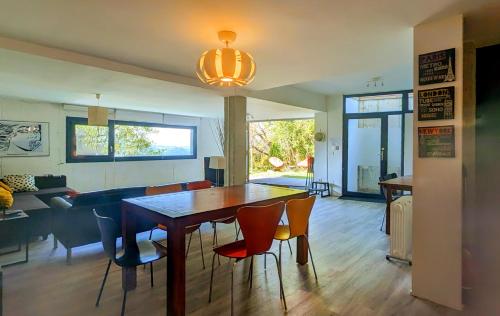 a dining room and living room with a table and chairs at Casa Cotera in Sierra