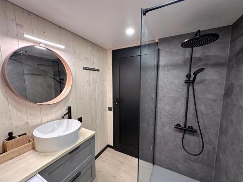 a bathroom with a sink and a shower at Lake Garden Villa in Sadžiūnai