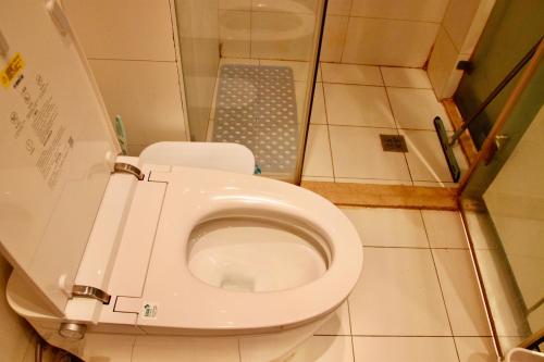a small bathroom with a toilet in a stall at Beijing city center - Cosy family suite with city view in Beijing