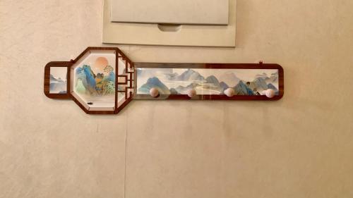a shelf with two mirrors on a wall at Beijing city center - Cosy family suite with city view in Beijing