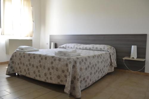 a bedroom with two beds with a table in it at Il Gattopardo in SantʼArcangelo