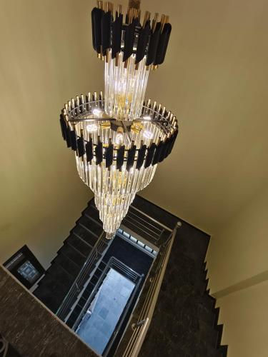 a chandelier hanging from the ceiling of a staircase at After House South Luxe 8BHK Pool Estate in Jaipur
