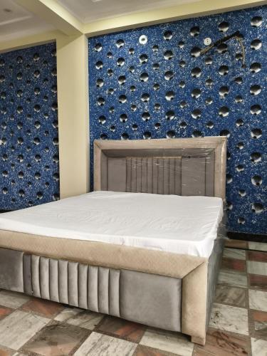 a bed in a room with a wall of wine bottles at After House South Luxe 8BHK Pool Estate in Jaipur