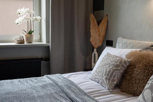 a bedroom with a bed with a pillow and a window at RixStay Apartments in Rīga