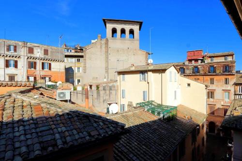 a view of roofs of buildings with a tower at Terrazze Navona in Rome