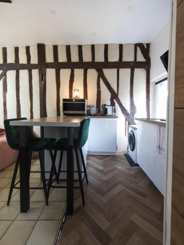 a dining room with a table and a kitchen at Studio hyper center of Tours in Tours