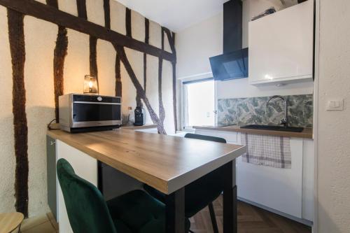 a kitchen with a wooden table with a microwave at Studio hyper center of Tours in Tours