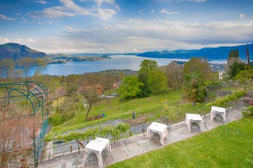 a view of a lake with tables and chairs at Locanda Chi Ghinn in Verbania