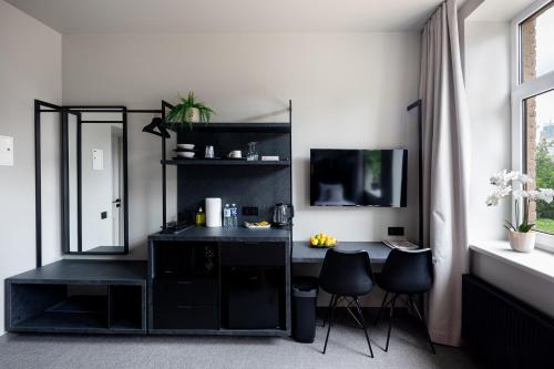 a black desk with two chairs in a room at RixStay Apartments in Rīga