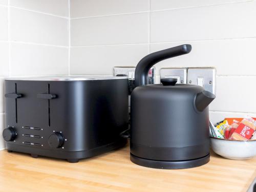 a black toaster sitting on top of a counter at Pass the Keys Poets' Corner Stylish Apartment Station Location in Brighton & Hove