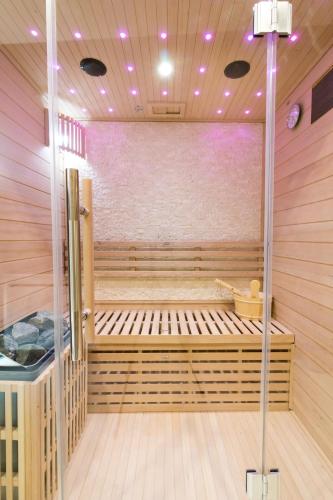 a sauna with a bench in the middle at L'Écrin Bohème - Jacuzzi & Sauna - Amiens in Amiens