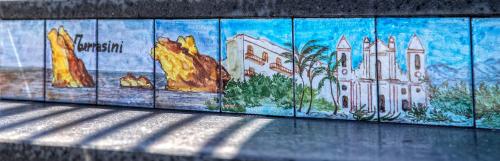 a wall with a painting of a city on it at Tra Le Braccia di Morfeo in Terrasini