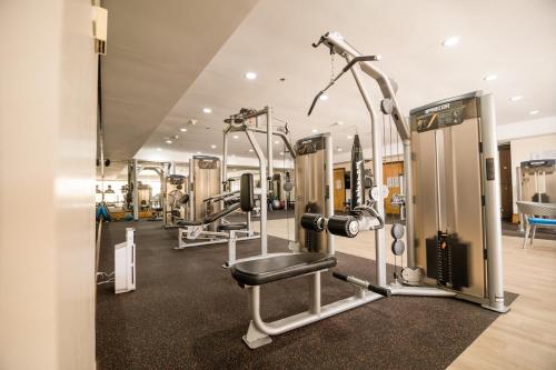 a gym with cardio equipment in a building at The Bellevue Manila in Manila