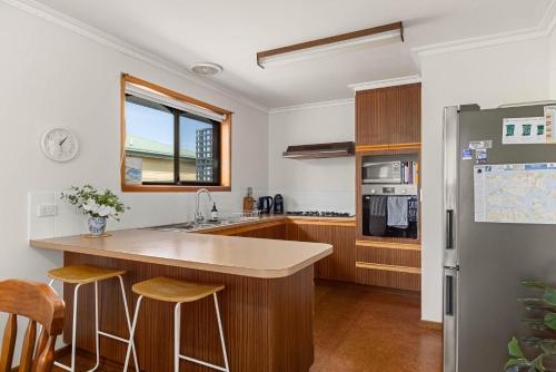 a kitchen with a counter and a refrigerator at Charming Cape Wooli Home in Cape Woolamai