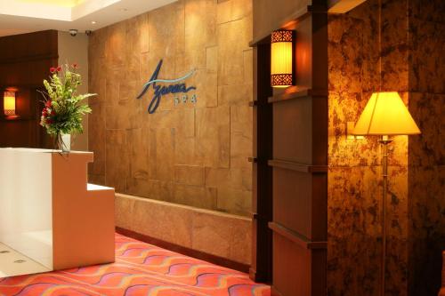 a hotel lobby with a sign on the wall at The Bellevue Manila in Manila