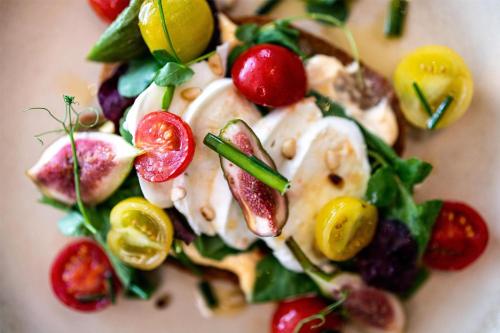 a plate of food with fruits and vegetables on it at Radisson Blu Media Harbour Hotel, Düsseldorf in Düsseldorf