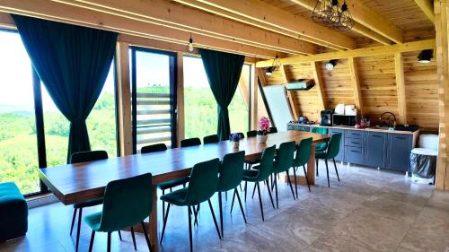 a large dining room with a long table and chairs at Cabana Brad Apuseni in Rîmeţi