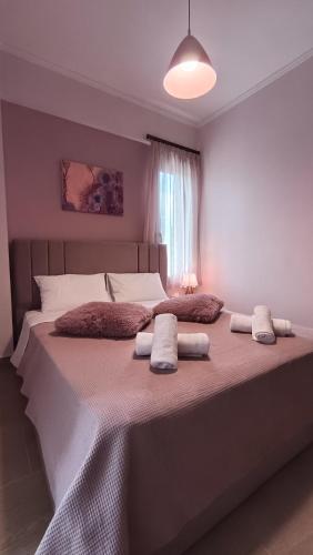 a bedroom with a large bed with pillows on it at GK Apartment in Kalavrita