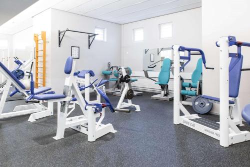 a gym with several treadmills and machines at Scandic Helsinki Aviapolis in Vantaa